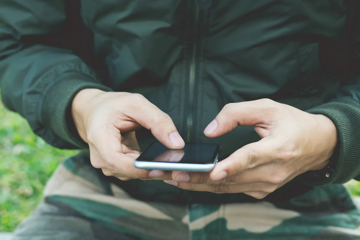 soldier-using-phone-dating-app.webp