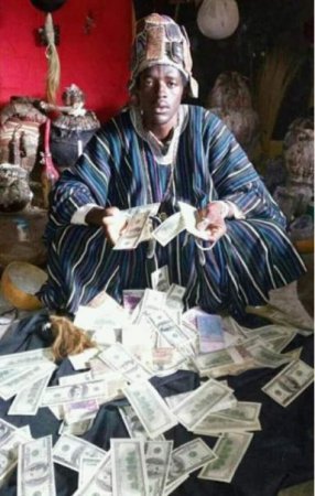 ogun-native-doctor- with dollars.jpg