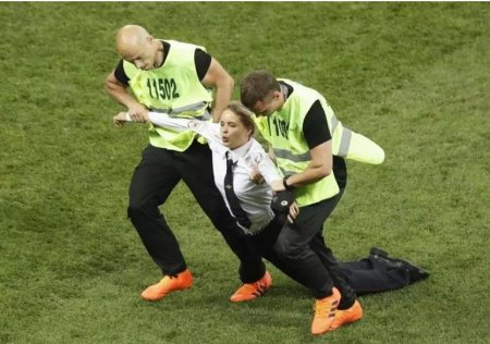 Boston-Globe-A woman was dragged away by stewards.JPG