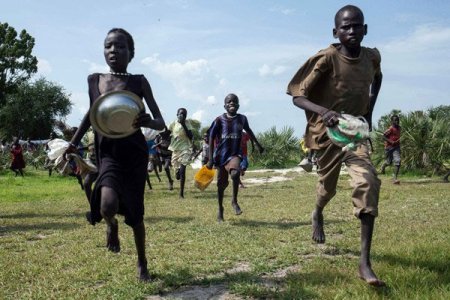 Daily Nation-Children run to a food drop-off point.jpg