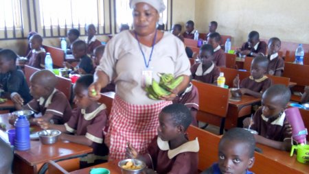 A school feeding vendor distributing lunch to pupils in South West Nigeria.jpg