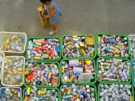 A girl recycles plastic and glass.jpg