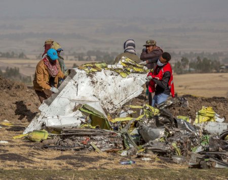 Workers collect wreckage from the crashed Ethiopia Airlines jet today.jpg