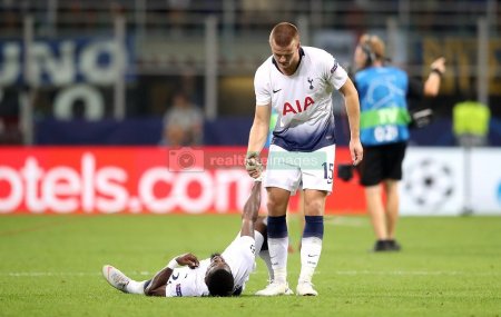 Eric Dier helps Aueier to stand up..jpg
