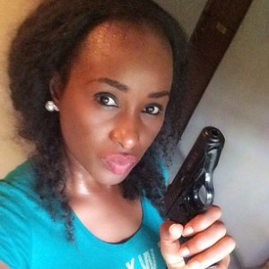 Nkemike holding a gun.jpg