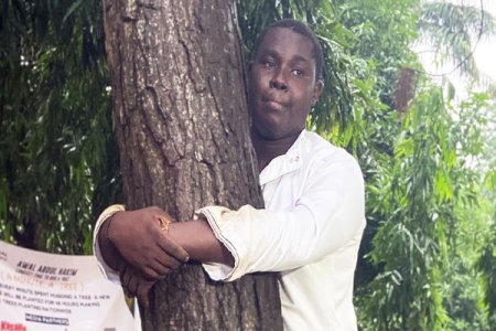 Nigerians Ridicule Ghanaians as Abdul Hakim Awal Breaks World Record for Longest Tree Hug