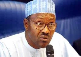 buhari speaking on a mic.webp