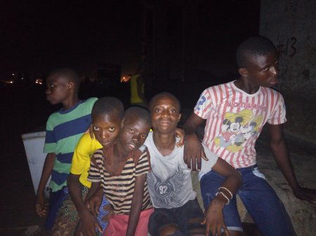 Child conductors at Orile under the railway bridge at night.jpg